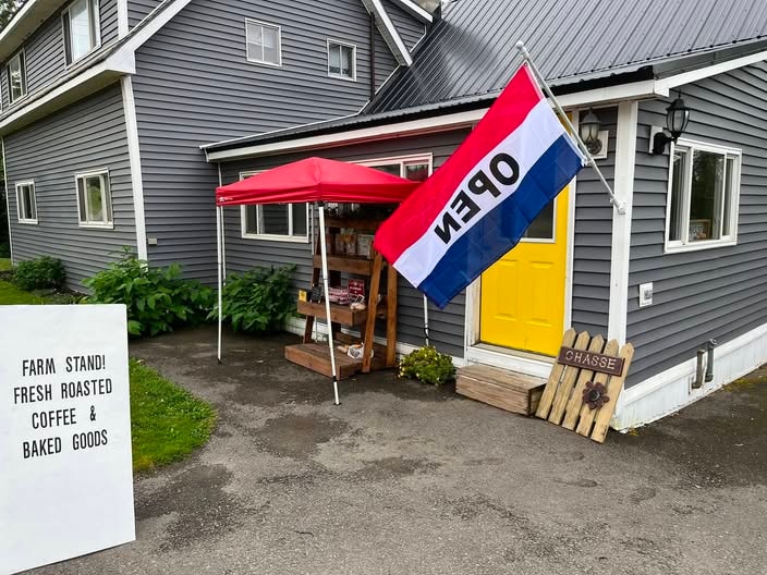 Shiretown Sweets and Treats roadside stand with an open flag and yellow door