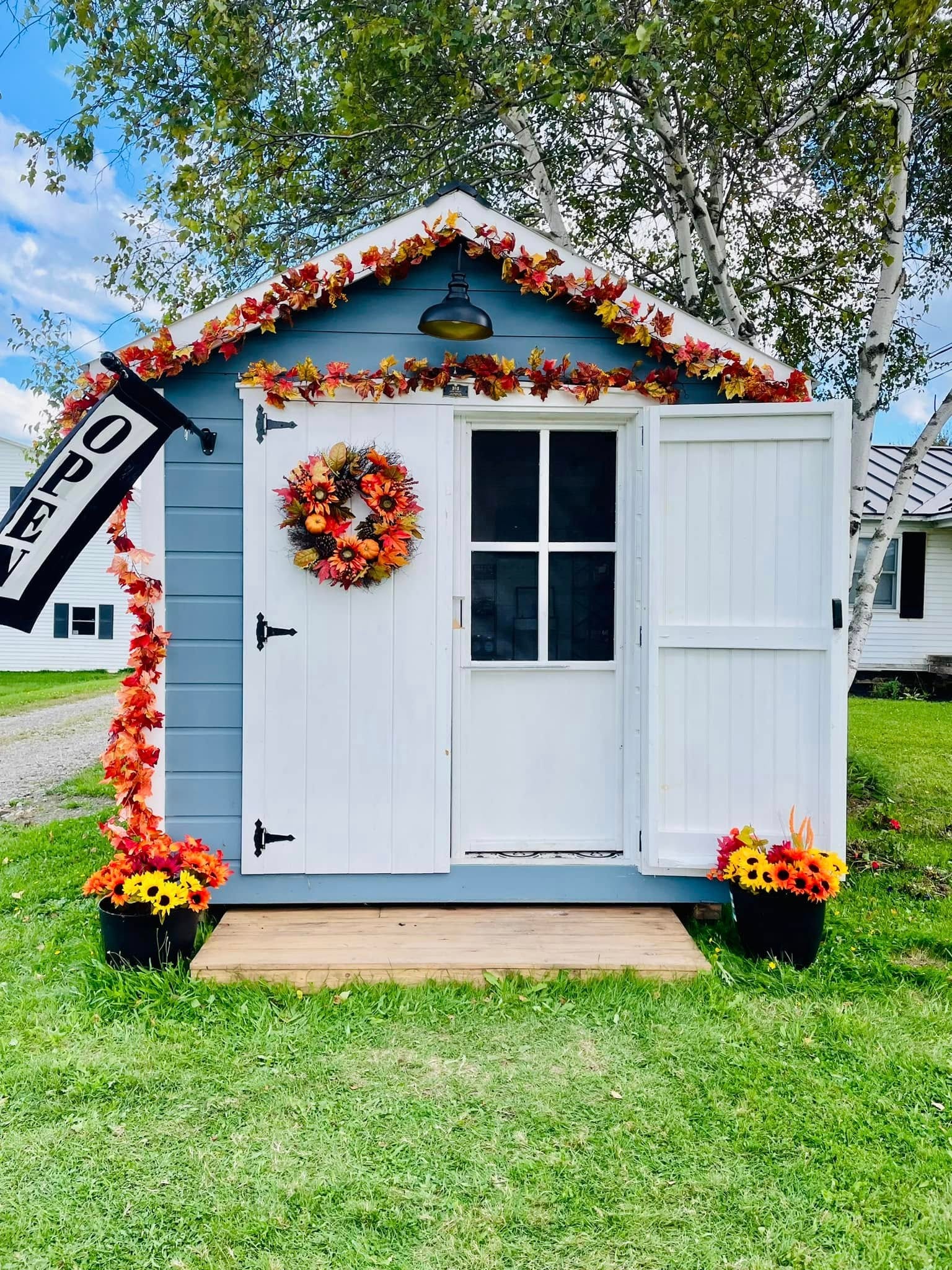Sweet Peas Pantry roadside stand decorated with autumn foliage and flowers