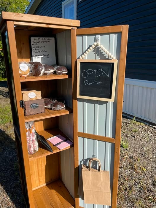 Wildflower Lane Bakery self-serve stand with homemade baked goods and an open sign